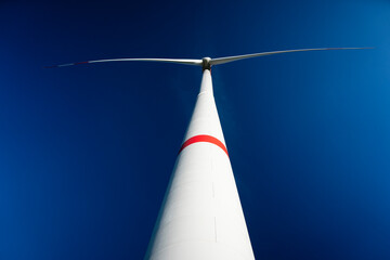 huge wind turbine blue sky frog perspective, green energy, renewable