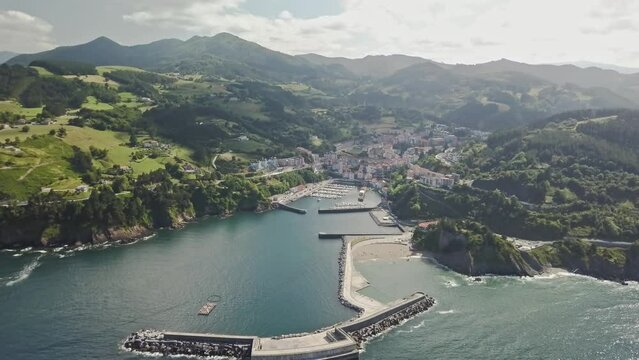 Aerial view high above the seaside town of Mutriku, northern Spain.  Yachts and boats moored in natural marina.