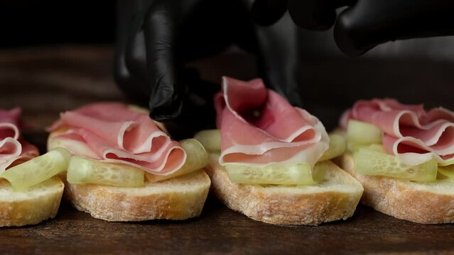Chef making sandwiches with Jamon or ham