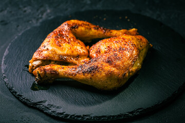 BBQ grilled chicken legs on black background