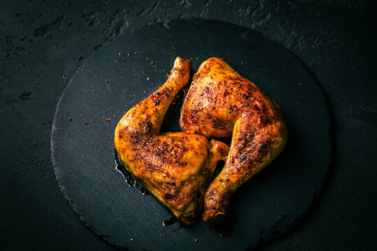BBQ grilled chicken legs on black background