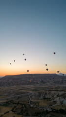 Hot air balloons. Hot air balloons flying over fairy chimneys in Cappadocia. Aerial view. Turkey tourist attractions