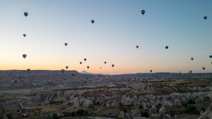 Hot air balloons. Hot air balloons flying over fairy chimneys in Cappadocia. Aerial view. Turkey tourist attractions