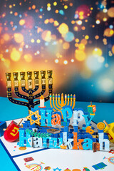 Jewish religious holiday Hanukkah with traditional chandelier menorah, spinning top toys.