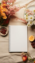 Notebook and autumn flowers on linen background. Flat lay, top view.