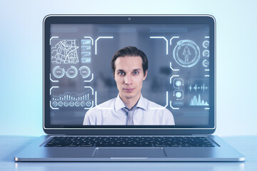 Close up of laptop with portrait of attractive pensive businessman with glowing face recognition hologram on blurry white background. Scanning and personal safety concept.