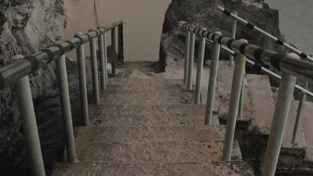 Pan up shot of stairs going down to Taga beach, Tinian island
