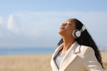 Black woman breathing listening audio in winter