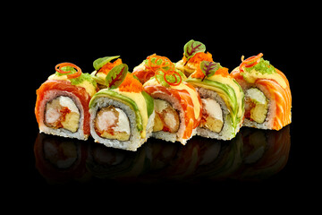 Close-up of sushi with salmon and avocado, cream cheese and shrimp on a dark background