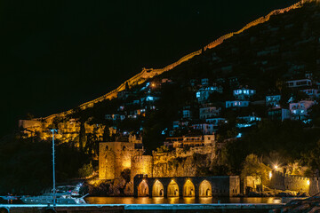 A bright star over the Alanya fortress and the shipyard in the night
