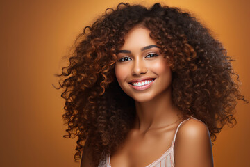 African beautiful woman portrait. Brunette curly haired young model with dark skin and perfect smile.