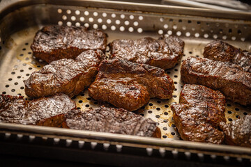 Pieces of grilled steak with fat