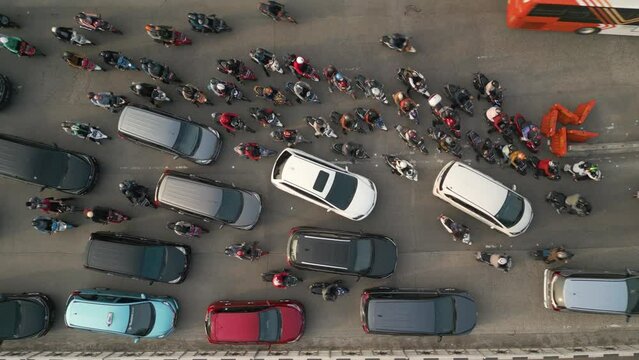 Top down Aerial view of crowded vehicles moving slowly on traffic jam at Central jakarta