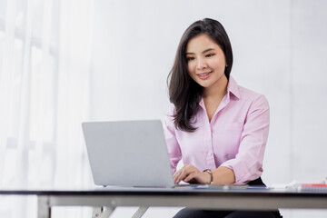 Business asian woman using calculator for do math finance in the office and business working background, tax, accounting, statistics and analytic research concept