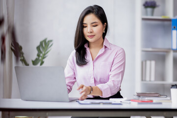 Business asian woman using calculator for do math finance in the office and business working background, tax, accounting, statistics and analytic research concept