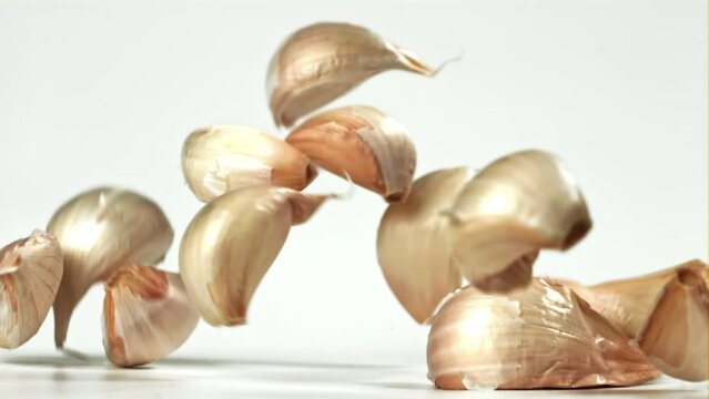 Fresh garlic falls on the table. Filmed on a high-speed camera at 1000 fps. High quality FullHD footage