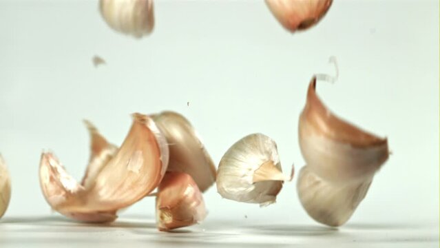 Fresh garlic falls on the table. Filmed on a high-speed camera at 1000 fps. High quality FullHD footage