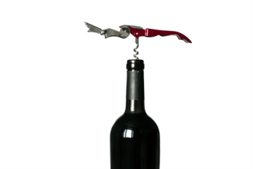 Corkscrew screwed into the cork of a bottle of red wine