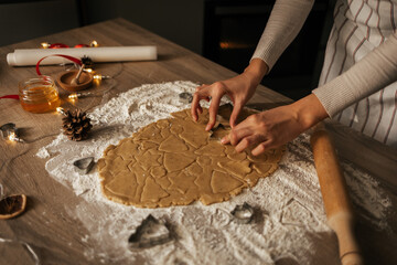 A close-up of the process of making New Year's gingerbread cookies in an atmospheric kitchen at...