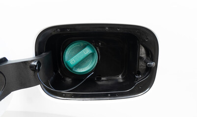 Fuel filler flap open with green diesel cap. Fuel tank cap of a car for filling. Car fuel tank hatch