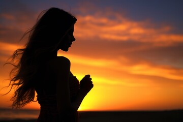 Fototapeta premium Silhouette of beautiful model woman walking in the sunset on the beach