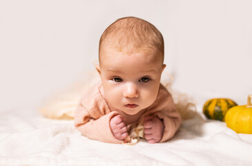Portrait of a cute little baby girl on a white background.