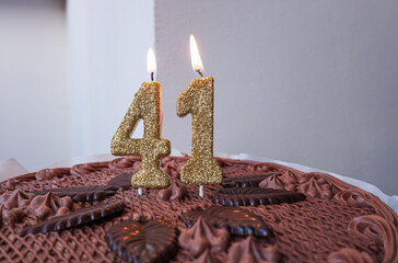 Birthday chocolate cake with candles number 41.