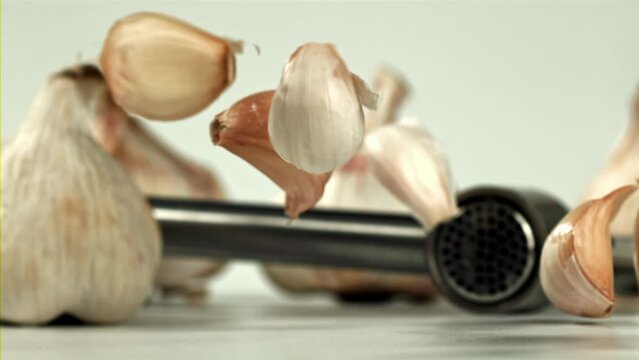 Fresh garlic falls on the table. Filmed on a high-speed camera at 1000 fps. High quality FullHD footage