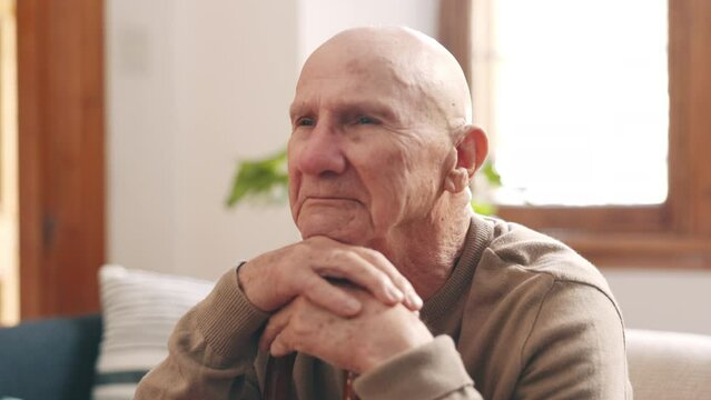 Thinking, sad and senior man on sofa in home with memories, nostalgia and reflection of past. Depression, retirement and lonely elderly person with unhappy, thoughtful and remember in living room
