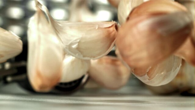 Fresh garlic falls on the table. Filmed on a high-speed camera at 1000 fps. High quality FullHD footage