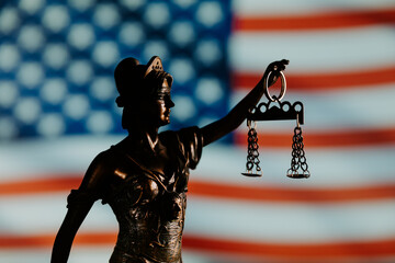 Antique statue of justice against USA flag