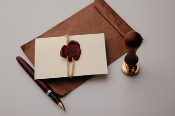 Envelope with wax stamp and pen on a table