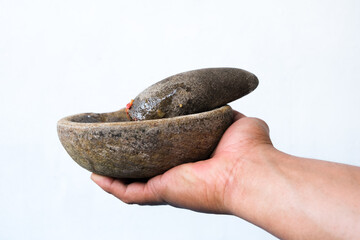 a spice grinding tool called a mortar or pestle isolated on a white background