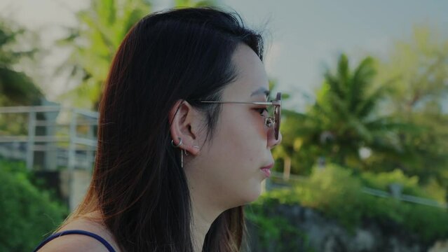 Close up shot of a girl exploring the beauty of an island