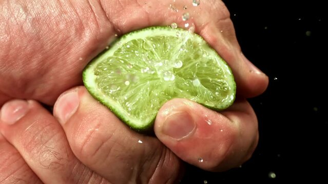 A man squeezes lime juice. Filmed on a high-speed camera at 1000 fps. High quality FullHD footage