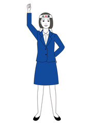 必勝ハチマキを頭に巻いてガッツポーズをしているスーツ姿の女性