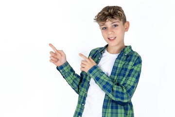 Caucasian teen boy indicating finger empty space showing best low prices, looking at the camera