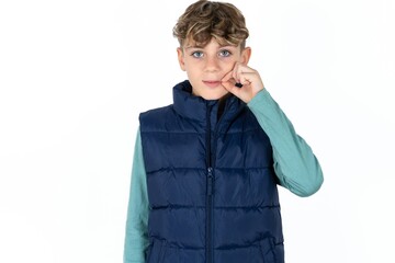 Caucasian teen boy mouth and lips shut as zip with fingers. Secret and silent, taboo talking.