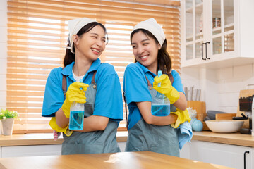 Group of Asian cleaning services worker female in uniform wearing apron standing in kitchen...