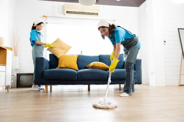 Professional housekeeper services company team working at customer house to clean up the floor, maid worker using mop wipe cleaning the dust, small business partnership female working together