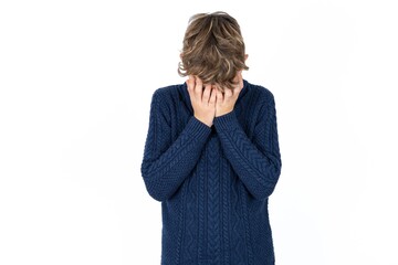 Caucasian teen boy covering her face with her hands, being devastated and crying. Sad concept
