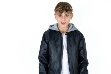Portrait of dissatisfied  caucasian kid boy wearing black jacket smirks face, purses lips and looks...