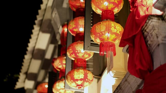 Red chinese lanterns illuminated at night. Chinese New Year Decorations.
