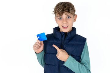 Photo portrait of  caucasian kid boy wearing blue vest  doing purchase with pointing finger credit...