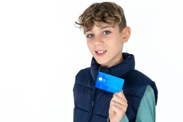 Close up photo of optimistic  caucasian kid boy wearing blue vest  hold card © Roquillo