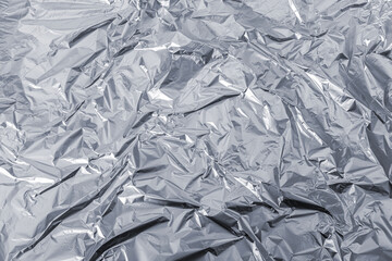 Abstract background of crumpled grey plastic film bag