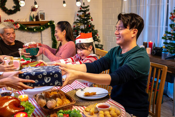 Happy people are celebrating on a table meal when christmas and new year at home.