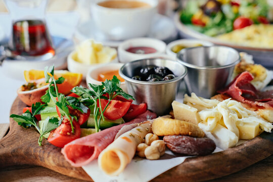 Close up picture of a Turkish breakfast - cheese, ham, olives, salad