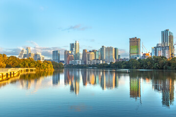 skyline of Austin in early morning light with mirroring city in the colorado river, Texas