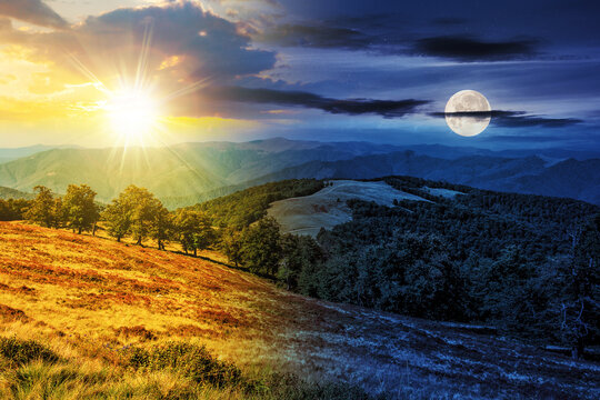 mountainous autumn landscape with sun and moon at twilight. meadow and beech forest on hill. day and night time change concept. mysterious nature scenery in morning light